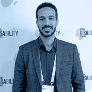 A man in a suit smiling.