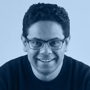 ChatGPT said: Person with curly hair in a dark sweater.