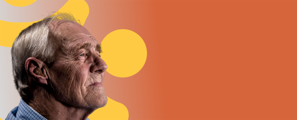 رجل مسن يرتدي قميصًا منقوشًا ويبدو مدروسًا، مع خلفية دائرية صفراء دافئة.